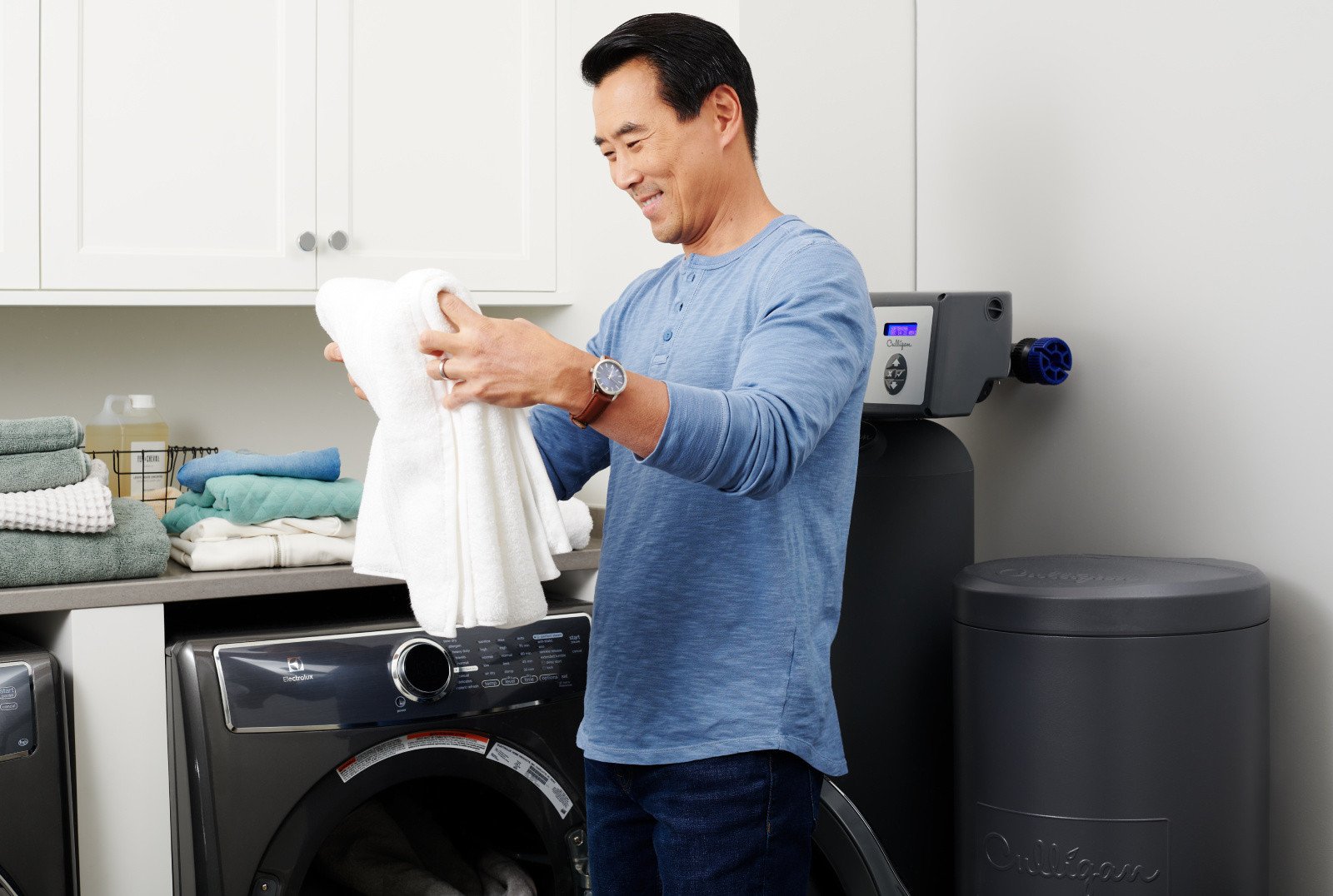 Person admiring freshly cleaned towels from the laundry